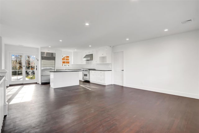 unfurnished living room with dark hardwood / wood-style flooring