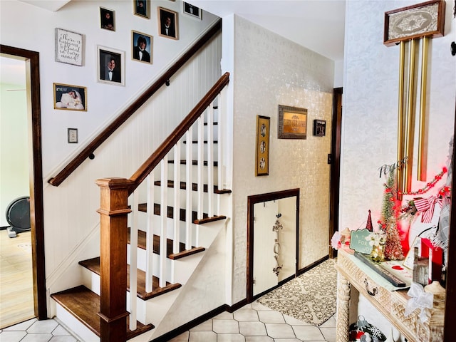 stairway with tile patterned floors