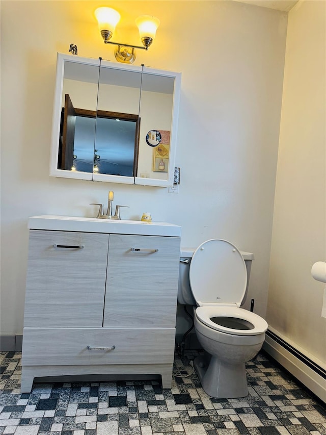 bathroom with baseboard heating, vanity, and toilet