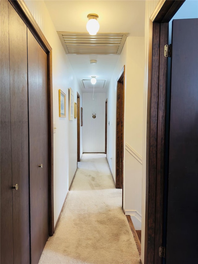 corridor featuring light colored carpet