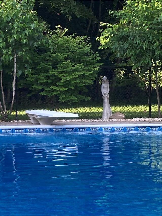 view of pool featuring a diving board