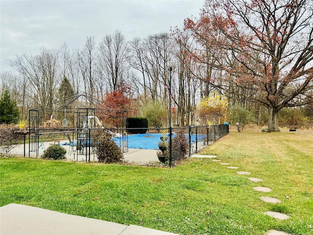 view of yard with a covered pool