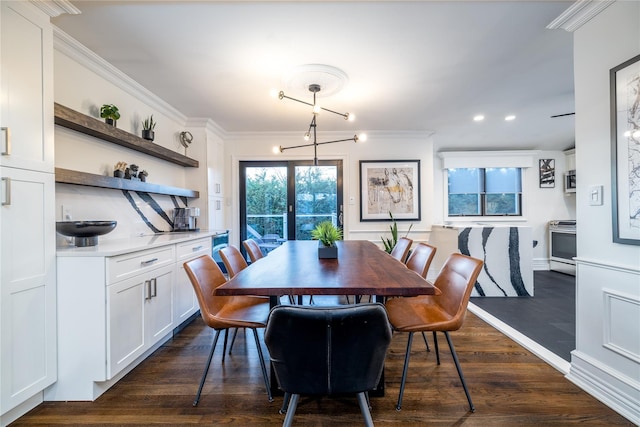 dining area featuring dark wood-type flooring and crown molding