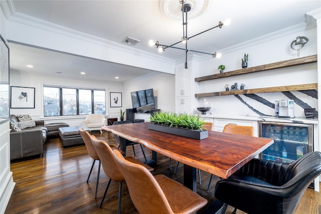 dining room featuring dark hardwood / wood-style floors, ornamental molding, and an inviting chandelier