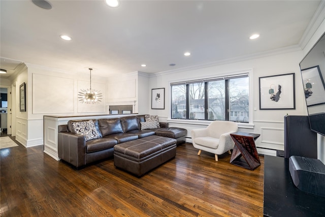 living room with a baseboard heating unit, dark wood-type flooring, ornamental molding, and a notable chandelier