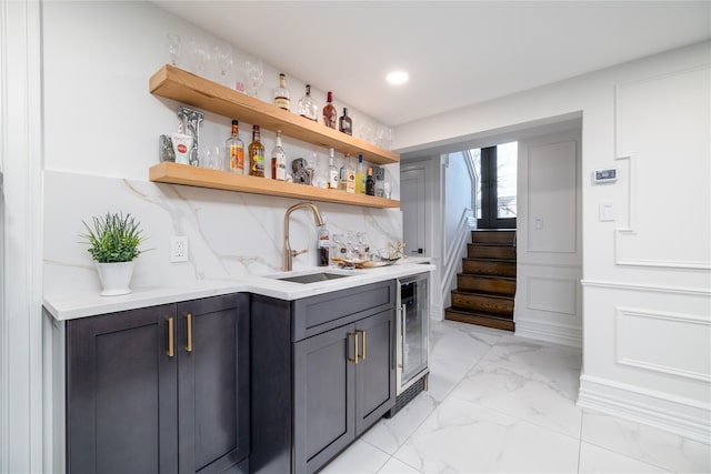 bar with wine cooler, backsplash, and sink