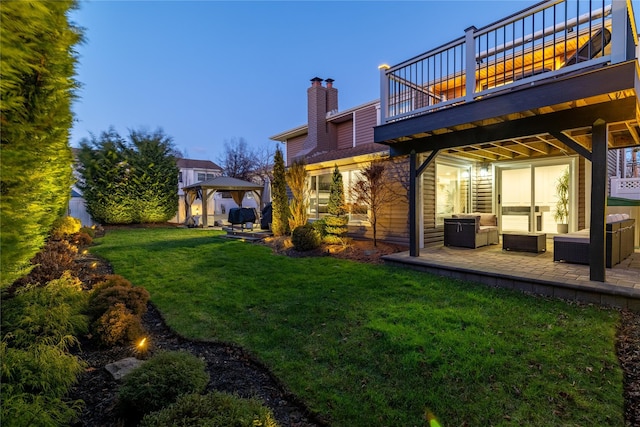 back house at dusk featuring an outdoor hangout area, a gazebo, a patio area, and a yard