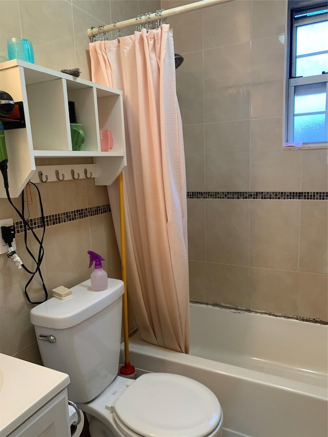 full bathroom featuring vanity, toilet, and shower / bathtub combination with curtain