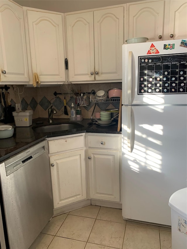 kitchen featuring backsplash, white cabinets, white refrigerator, dishwasher, and light tile patterned flooring