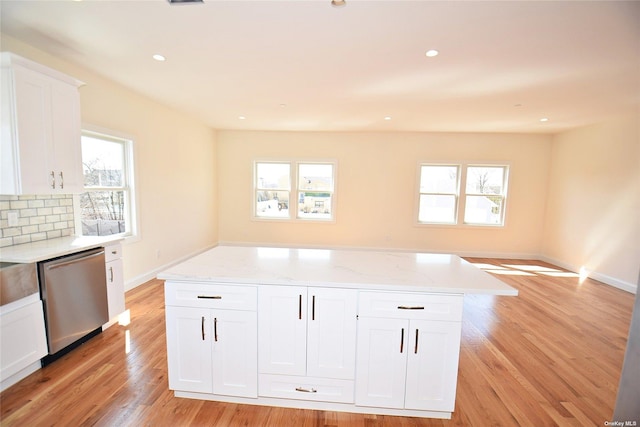 kitchen featuring dishwasher, decorative backsplash, white cabinets, and plenty of natural light