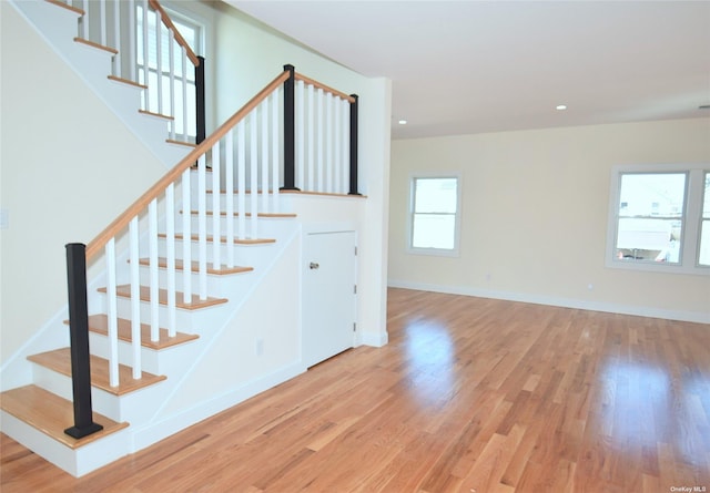 staircase with hardwood / wood-style flooring