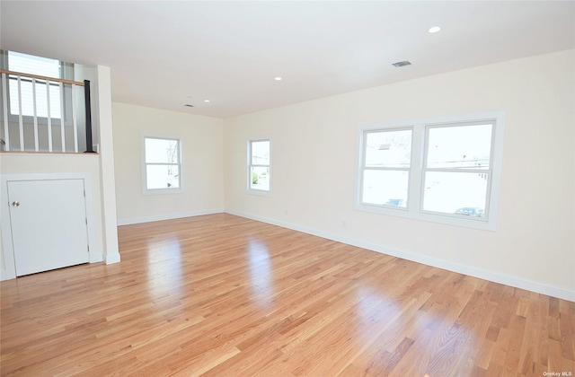 unfurnished room with light hardwood / wood-style floors