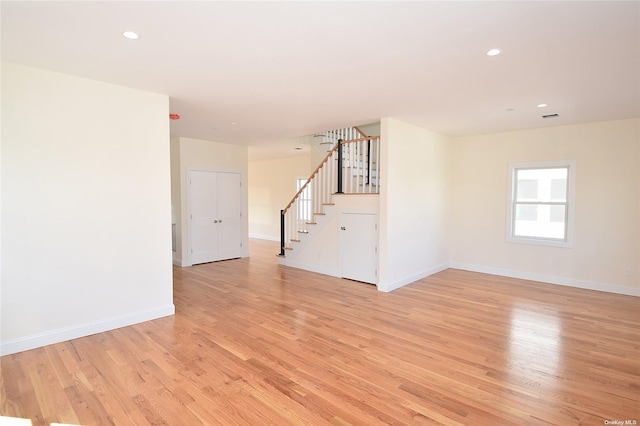 empty room with light hardwood / wood-style flooring