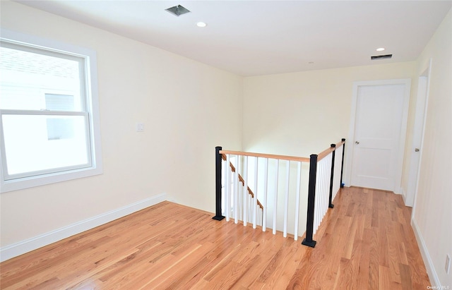 hallway featuring light hardwood / wood-style flooring and a healthy amount of sunlight