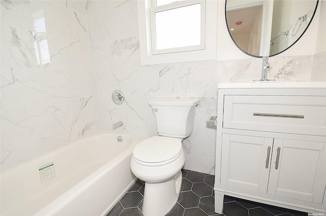 full bathroom with tile patterned floors, vanity, shower / bathing tub combination, tile walls, and toilet