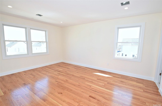 unfurnished room with light hardwood / wood-style flooring and a healthy amount of sunlight