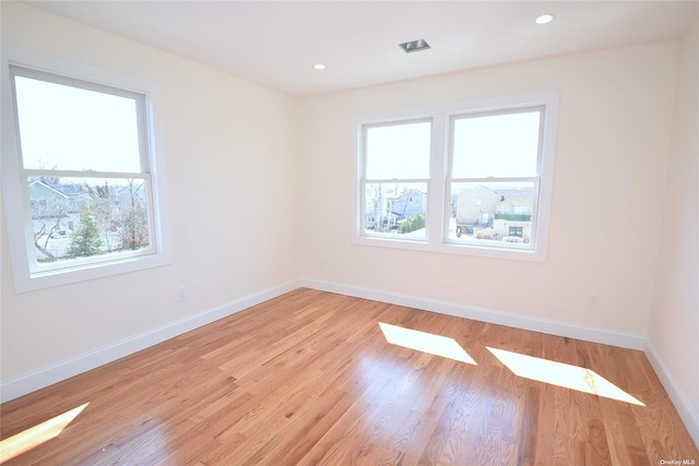 spare room featuring light wood-type flooring