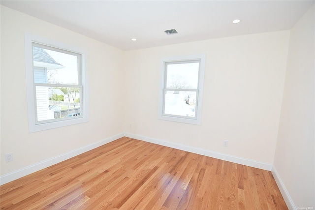 unfurnished room with light hardwood / wood-style floors