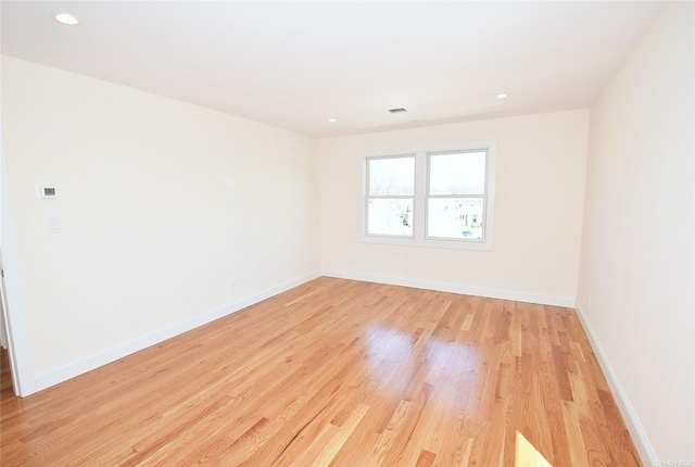 unfurnished room with light wood-type flooring