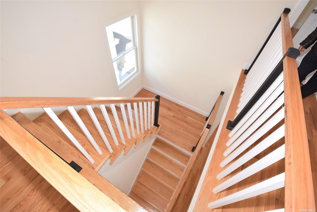 stairs featuring hardwood / wood-style flooring