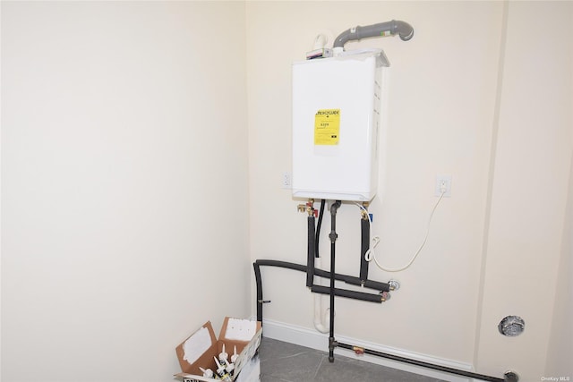 utility room featuring tankless water heater