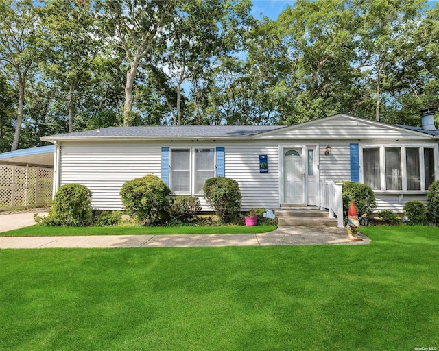 ranch-style home featuring a front yard and a carport