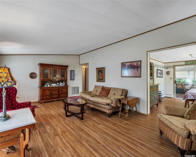 living room featuring hardwood / wood-style flooring, crown molding, and a baseboard heating unit