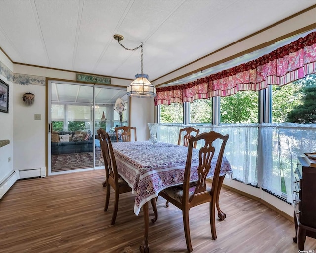 dining area with plenty of natural light, wood-type flooring, and a textured ceiling