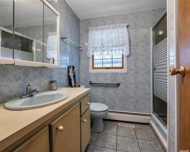 bathroom with vanity, a baseboard radiator, tile patterned flooring, toilet, and a shower with shower door