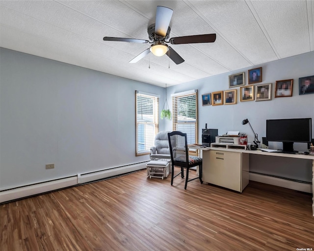 home office featuring a textured ceiling, hardwood / wood-style flooring, ceiling fan, and a baseboard heating unit