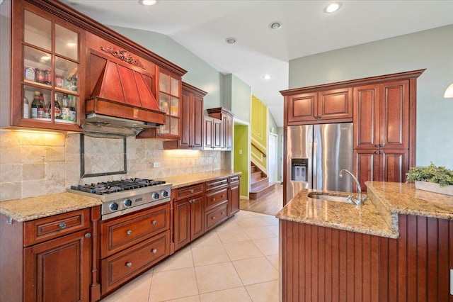 kitchen featuring lofted ceiling, premium range hood, sink, tasteful backsplash, and stainless steel appliances