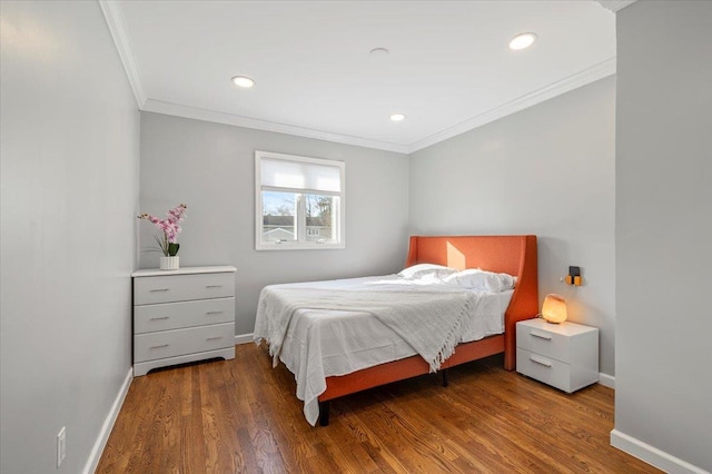 bedroom featuring dark hardwood / wood-style flooring and crown molding