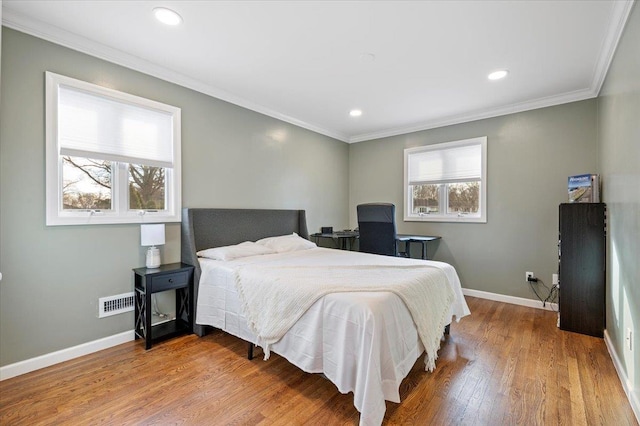 bedroom with crown molding and hardwood / wood-style flooring