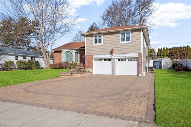 view of front of home featuring a storage unit, a front yard, and a garage