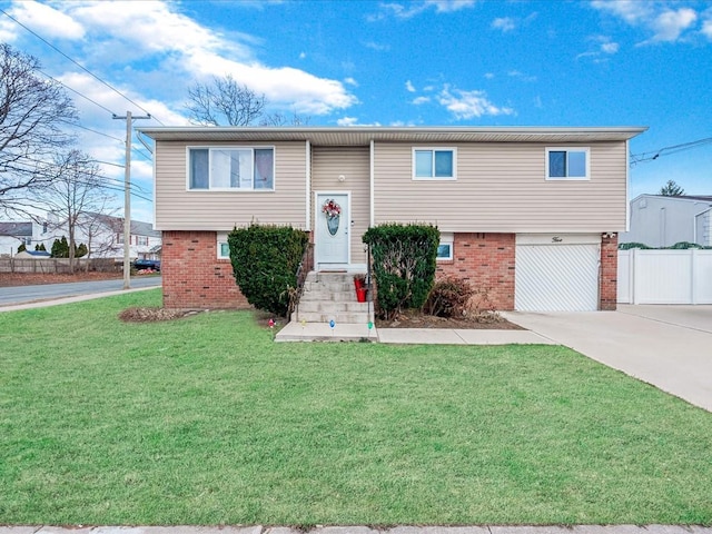 split foyer home featuring a front yard and a garage