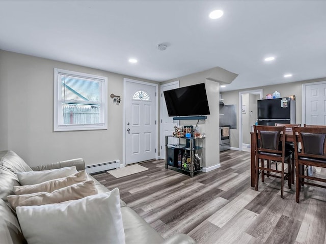 living room featuring wood-type flooring and baseboard heating