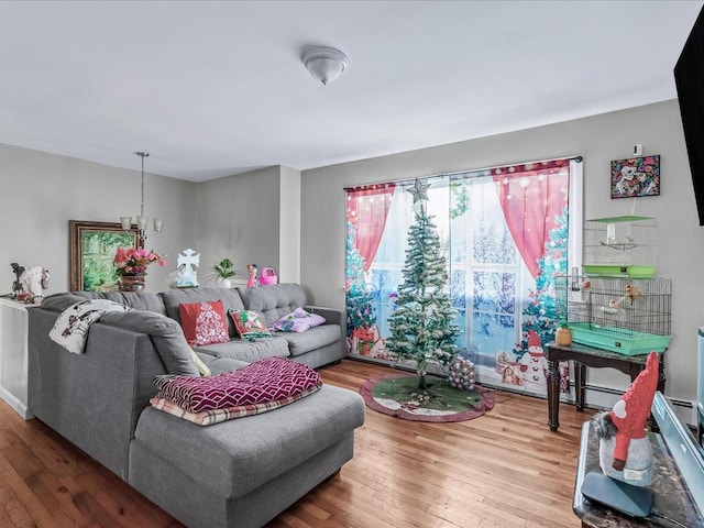 living room featuring hardwood / wood-style flooring, an inviting chandelier, and a wealth of natural light