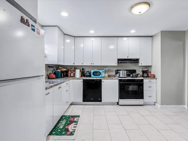 kitchen featuring white cabinets, light stone counters, and white appliances