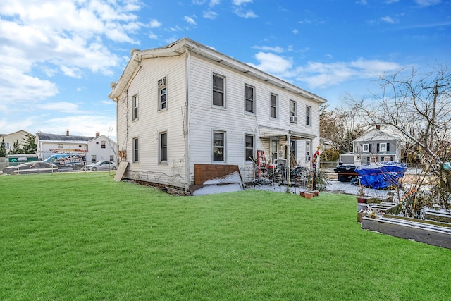 back of house featuring a lawn