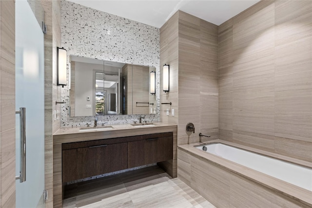 bathroom featuring vanity, tile patterned floors, tile walls, and tiled tub