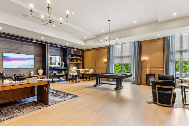 recreation room featuring built in shelves, a chandelier, light hardwood / wood-style floors, and billiards