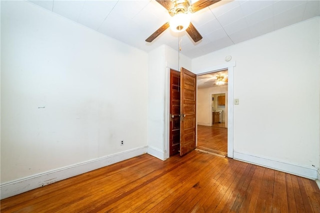 spare room with wood-type flooring and ceiling fan