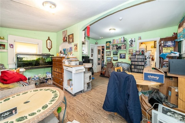 misc room with light hardwood / wood-style floors and lofted ceiling