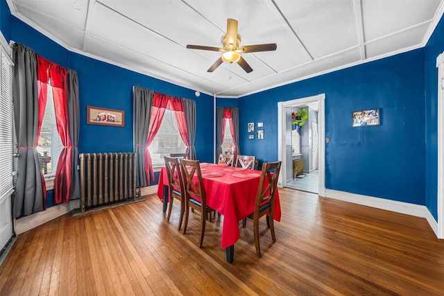 dining space with radiator, ceiling fan, and wood-type flooring