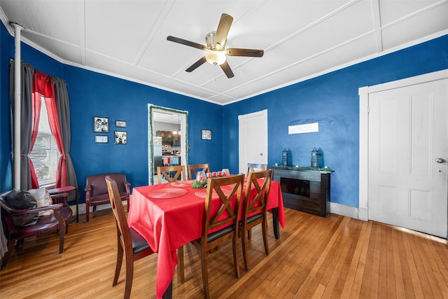 dining area with hardwood / wood-style flooring and ceiling fan