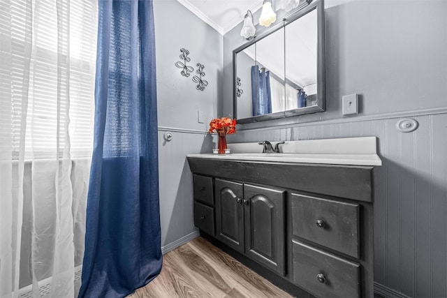 bathroom with hardwood / wood-style floors, vanity, and crown molding