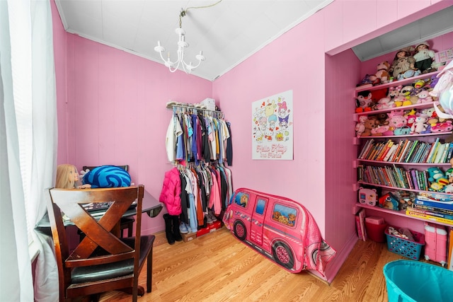 spacious closet featuring wood-type flooring and a notable chandelier