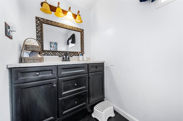 bathroom with vanity and ornamental molding