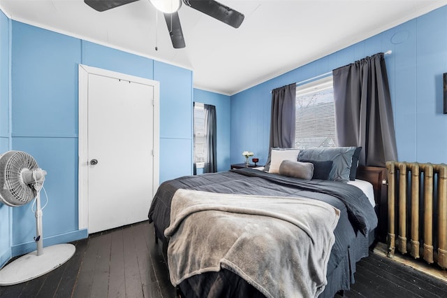 bedroom featuring ceiling fan, dark hardwood / wood-style flooring, and radiator