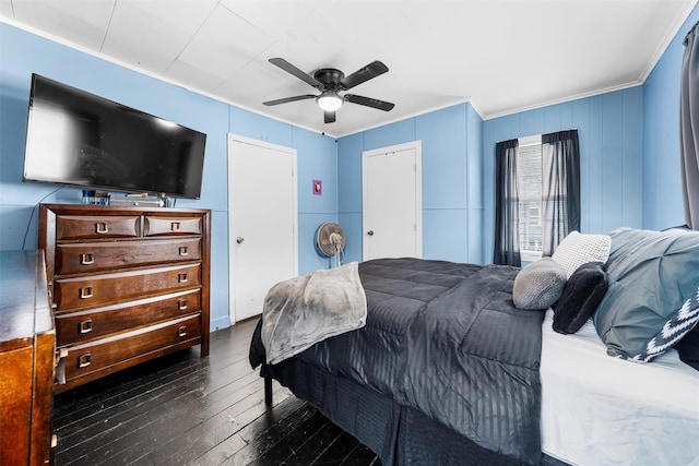 bedroom with ceiling fan, dark wood-type flooring, and ornamental molding